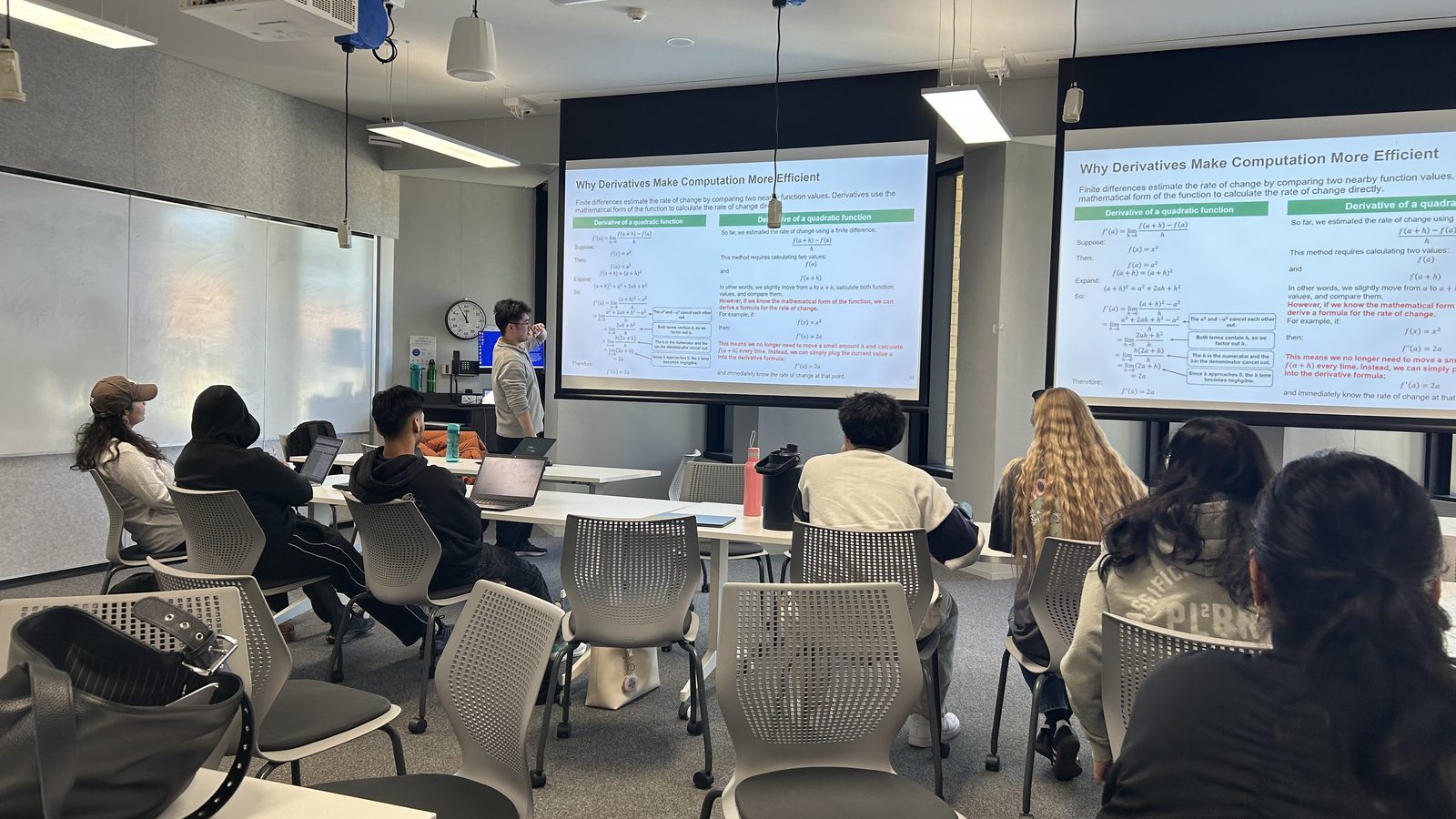 A Winter Projects session in progress, with a team presenting to the room from two screens